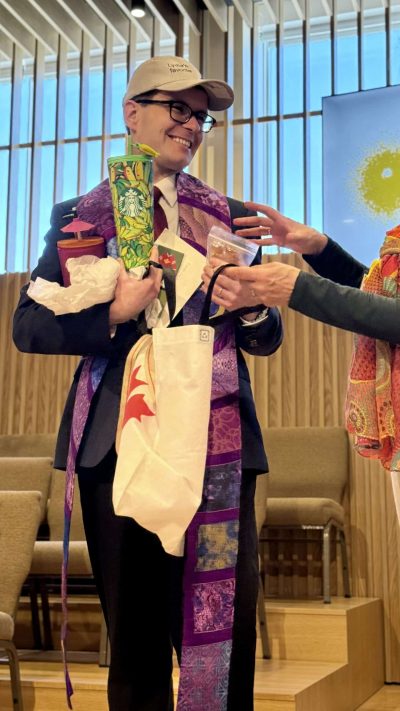 Beth Ann overloads Rev Alex with Toronto swag. Beth Ann overloads Rev Alex with Toronto swag.