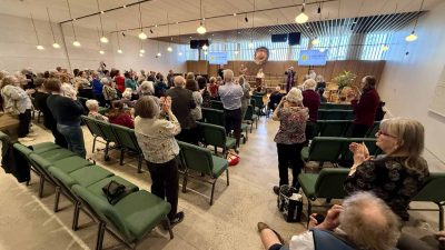 Tanya announces the results of the vote to a joyful congregation