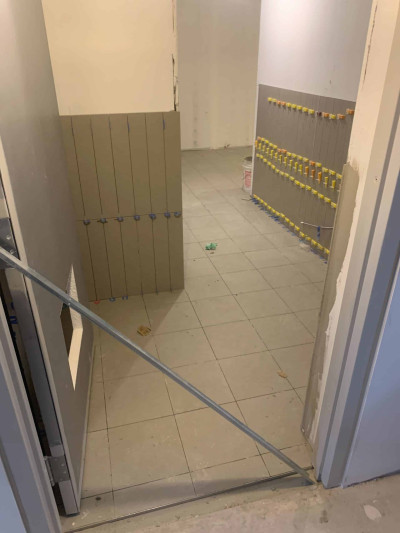 Tiling the floor of one of the bathrooms Tiling the floor of one of the bathrooms