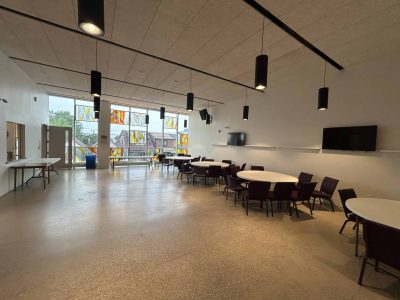Community Hall - Looking West; Windows look onto Oakwood Ave; Door on the left goes into the Kitchen
